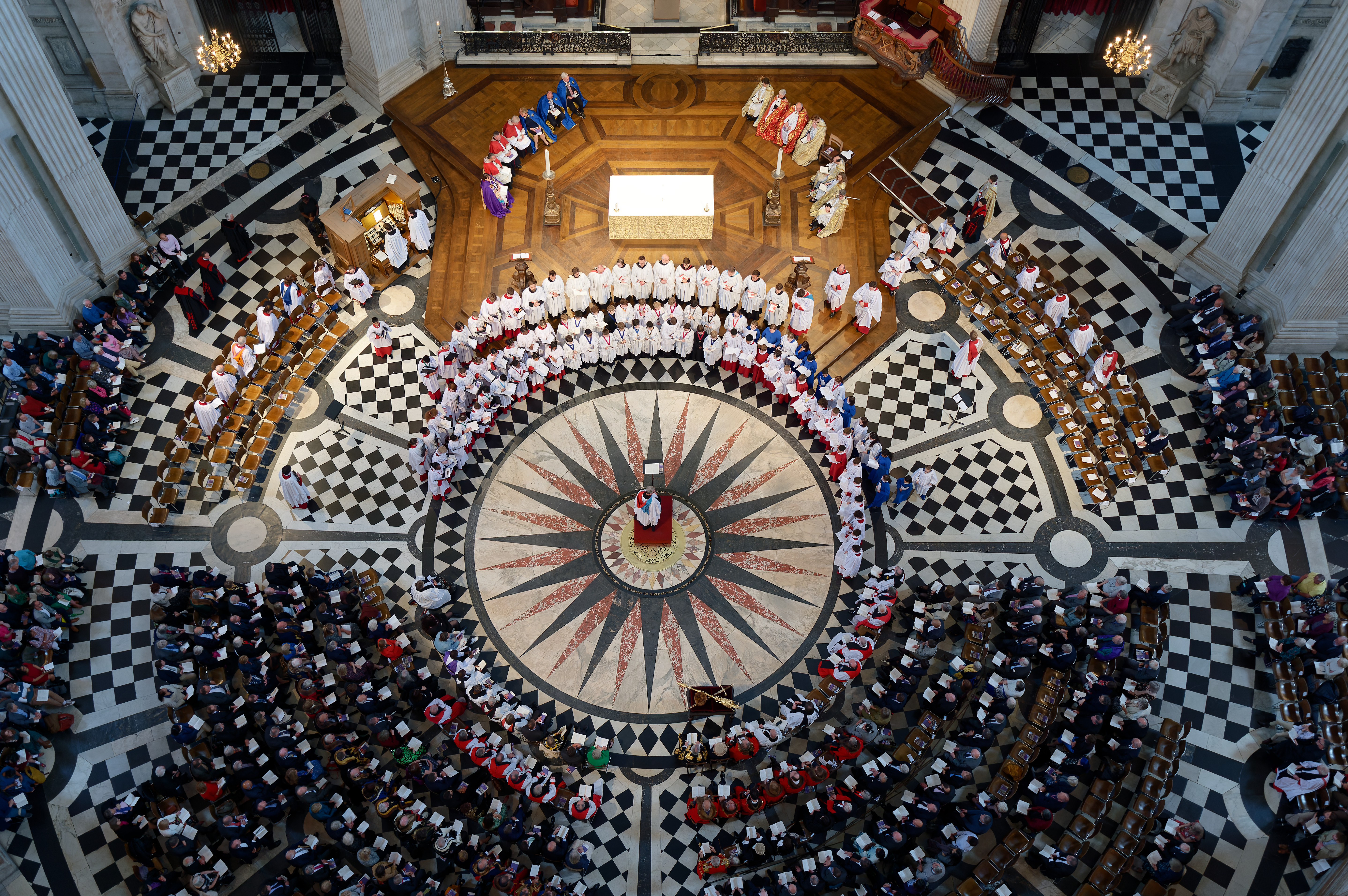 A bird's eye view, taken from the dome of St Paul's Cathedral, of the three combined choirs performing together in a semi-circle formation.