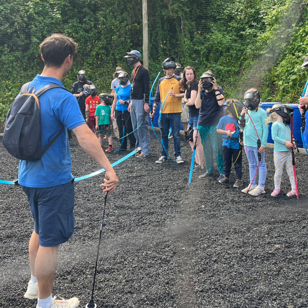 Children holding bows, preparing to learn about archery!