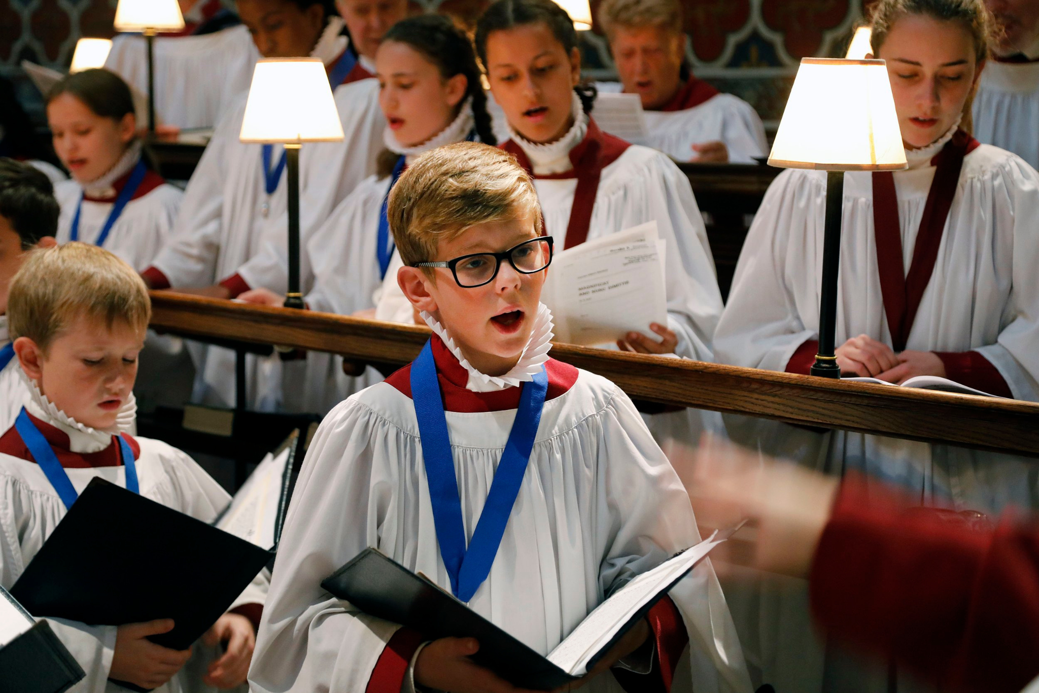 A young chorister in Rochester Cathedral Choir, dressed in a white robe.