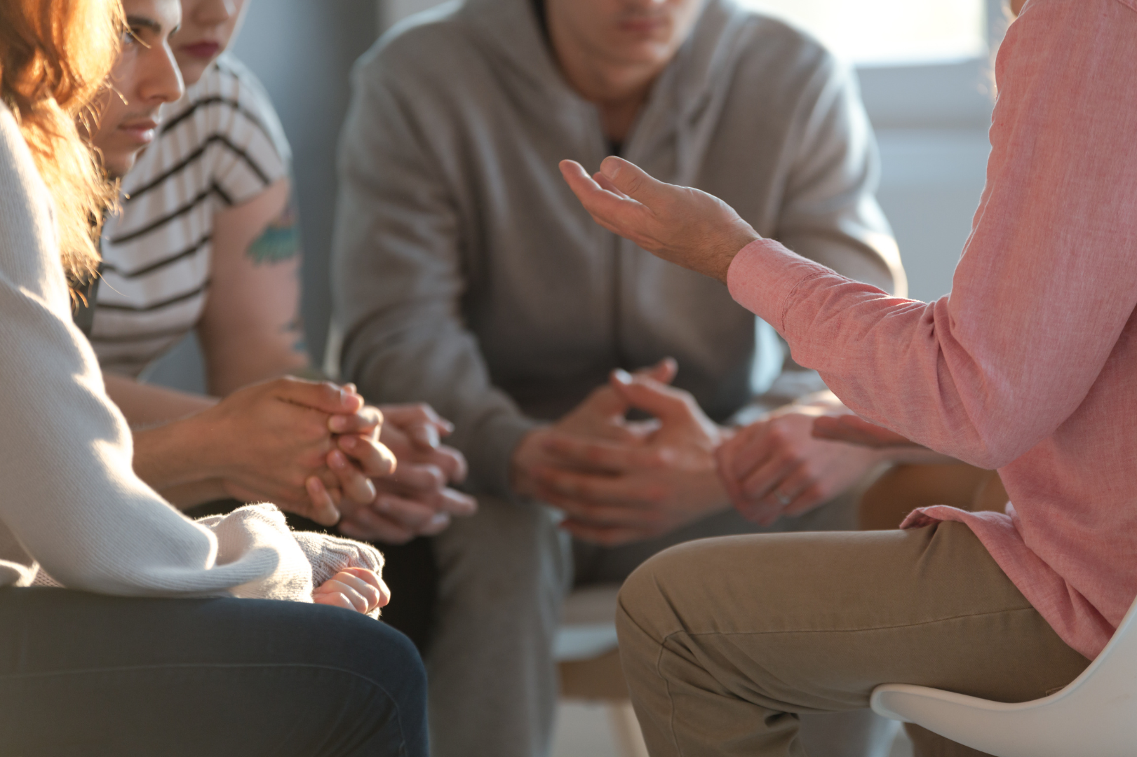 A support group, people talking while seated.