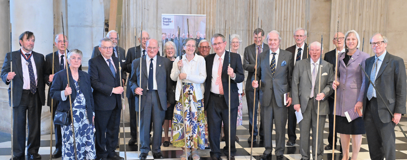 Our Stewards of the Festival, a group of men and women, dressed formally and holding ceremonial wands.