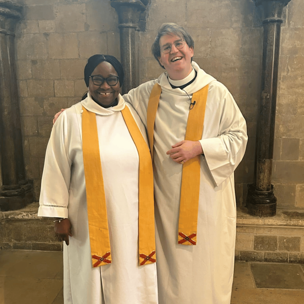 The Revd Ethlyn Roy-Johnson and The Revd Ben Cahill-Nicholls, dressed in white robes.