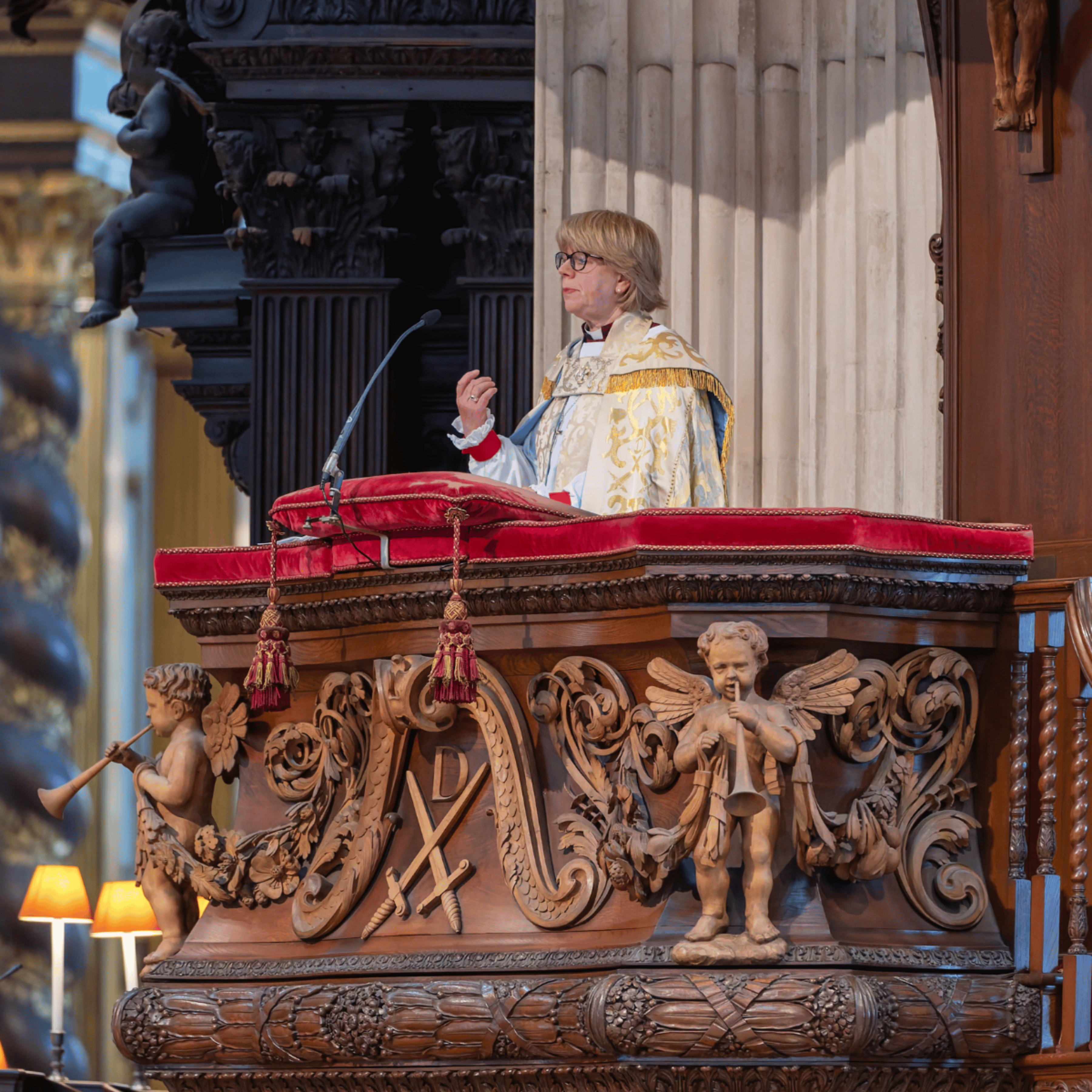 The Archbishop of Canterbury, The Most Revd and Rt Hone Dame Sarah Mullally is giving the sermon, standing in a wooden pulpit.