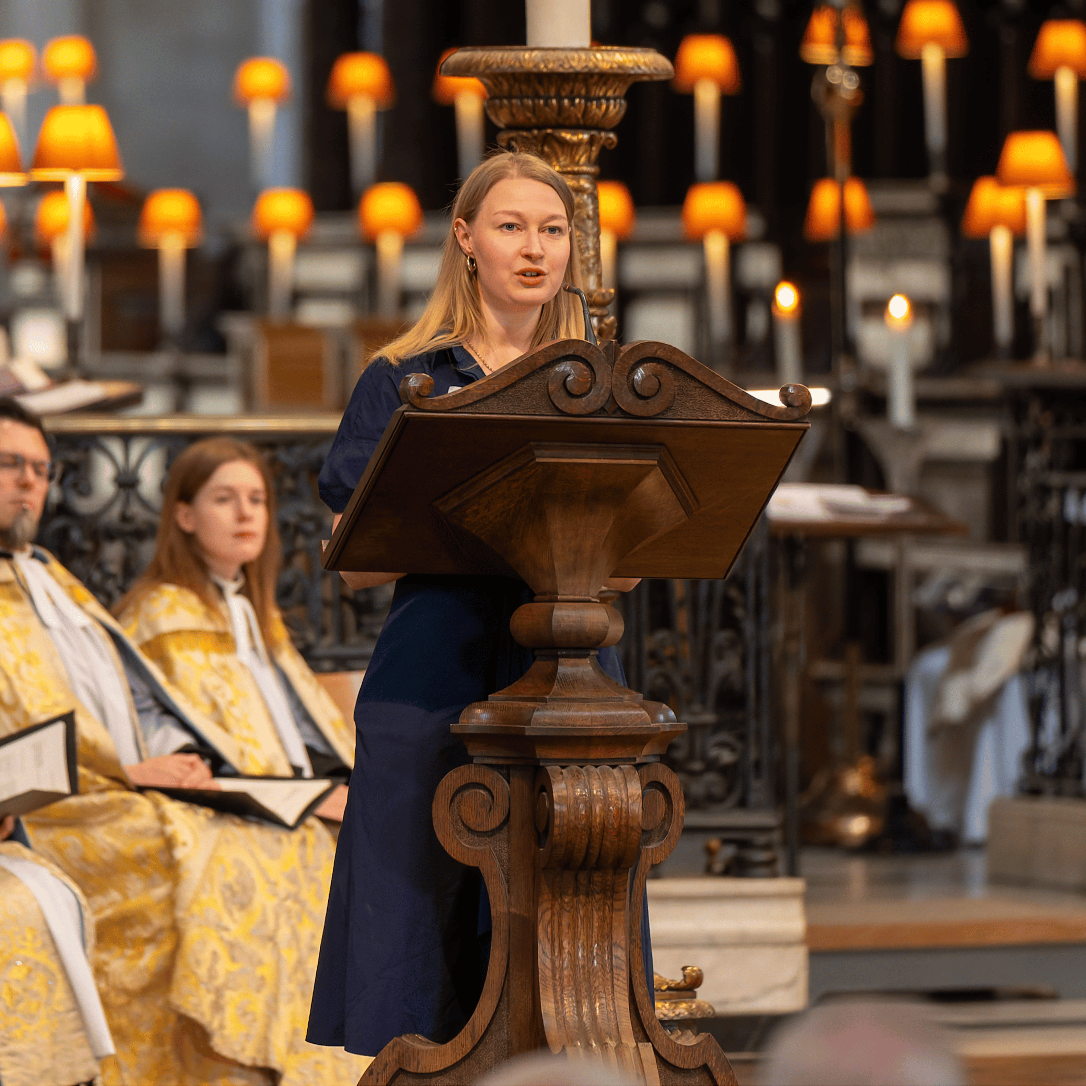 Heidi Gower, speaking from behind a wooden lectern.