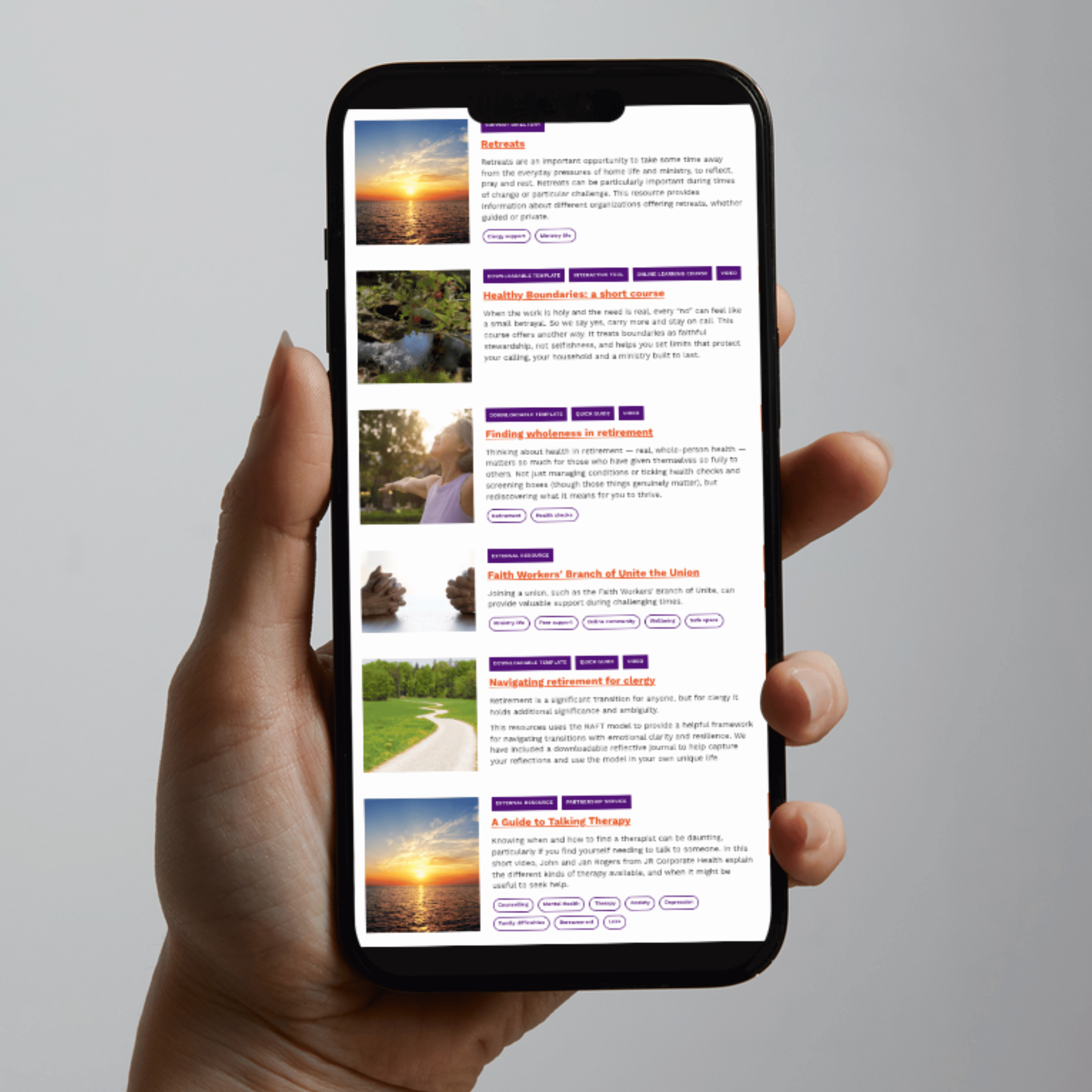 The Clergy Support Hub, on the screen of a mobile phone, held upright by a woman's hand.