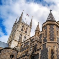 The exterior of Southwark Cathedral, against a cloudy backdrop.