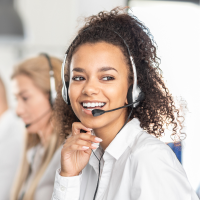 A woman wearing a headset, talking on the phone.