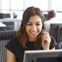 A woman wearing a headset, talking on the phone.