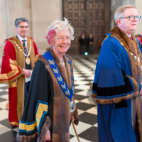 A Worshipful Company Master, dressed in formal robes, processing through the nave of St Paul's Cathedral.